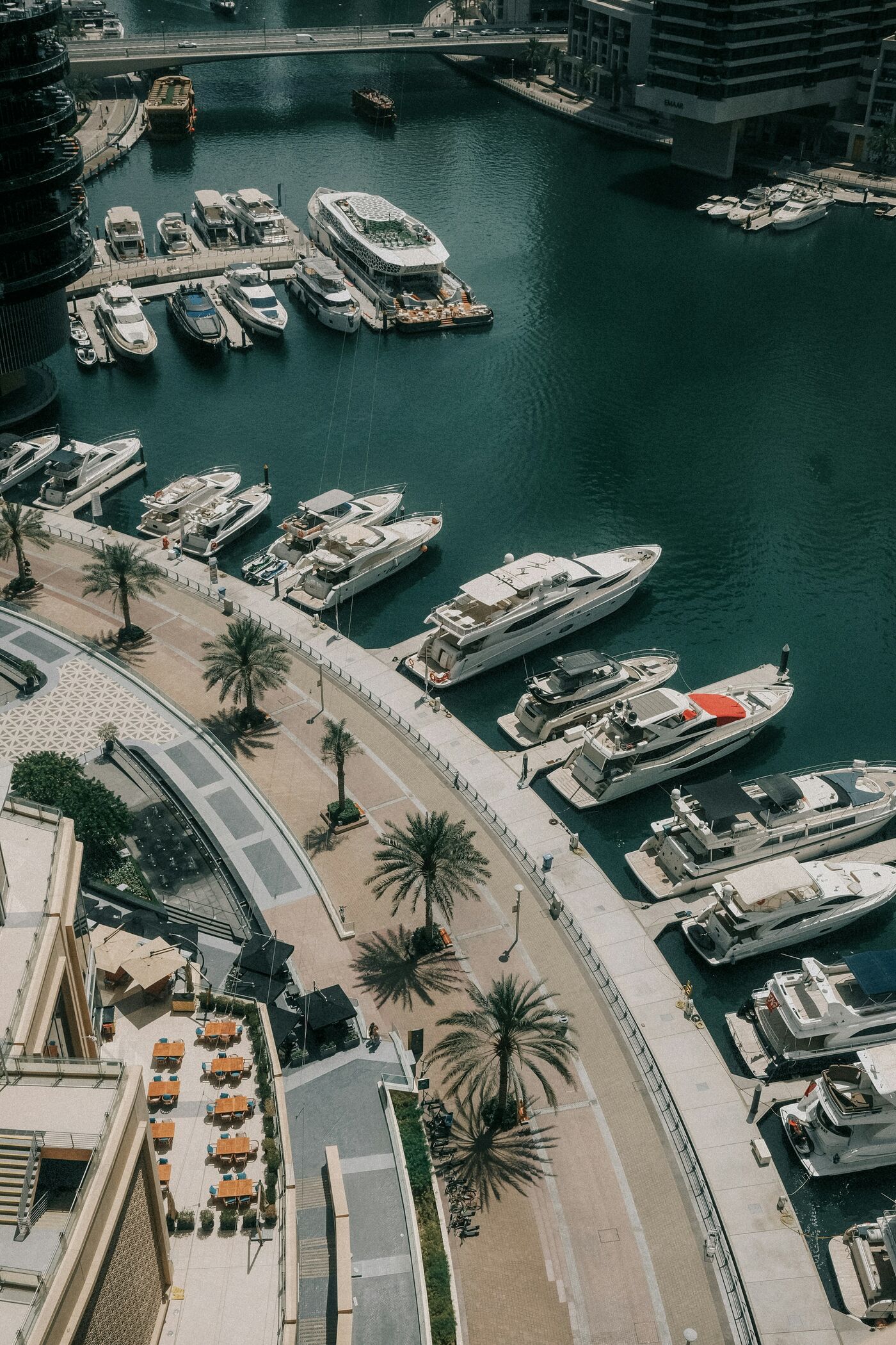 Yachts lying stern-to along a marina pontoon, seen from directly overhead